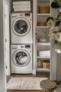 a washer and dryer in a room with open shelving on the wall