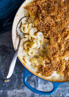 macaroni and cheese in a blue pot with a spoon