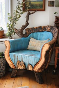 a chair made out of wood with blue upholstered seat and pillows on it