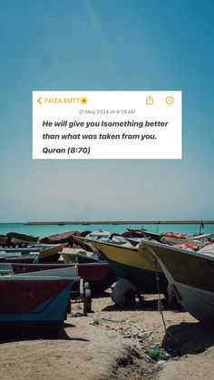 there are many small boats sitting on the beach and one is in front of the water