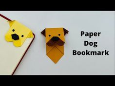 two origami dogs made out of paper are sitting next to each other with the words paper dog bookmark