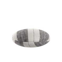 a gray and white striped pillow sitting on top of a table