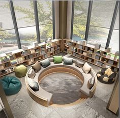 a circular couch sitting in the middle of a living room filled with bookshelves