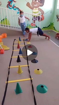 two children playing with an interactive game in a play room