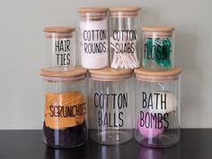 there are many jars that have different types of yarn in them and labeled with words