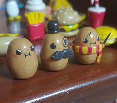 some toys are sitting on a table with food in the shape of buns and hamburgers