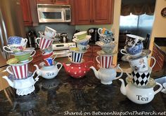 a kitchen counter topped with lots of cups and saucers