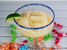 a margarita sitting on top of a table next to confetti