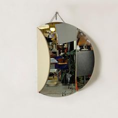 a mirror hanging from the side of a wall