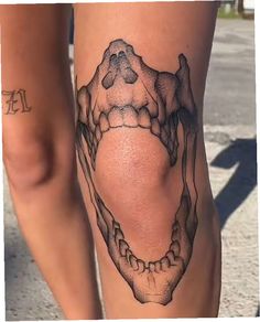 a woman's leg with a tattoo on it that is shaped like a skull