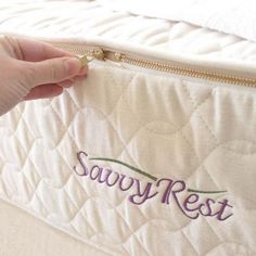 someone is holding onto the side of a mattress that says savy rest on it