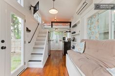 the interior of a tiny house with stairs