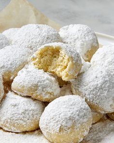 powdered sugar covered doughnuts piled on top of each other