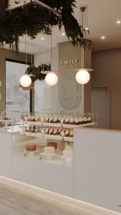 the interior of a bakery with cupcakes on display