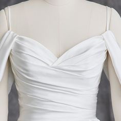 the back of a white wedding dress on a mannequin headdress,