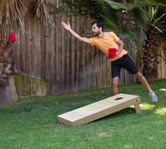 a man is throwing a frisbee in the back yard