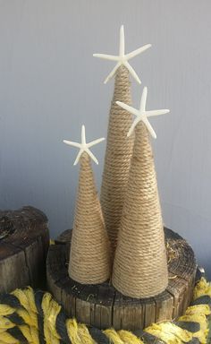 three small christmas trees made out of rope