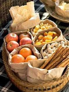 an assortment of fruits and crackers in baskets