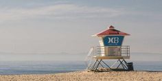 a lifeguard tower sitting on top of a sandy beach