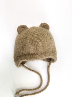 a knitted hat with ears is shown on a white surface