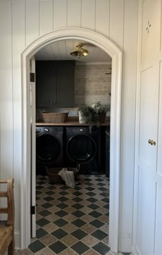 a washer and dryer sitting in a room next to each other on top of a checkered floor