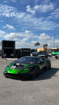 a green and black sports car parked in a parking lot