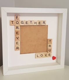 a scrabble frame with the words together on it