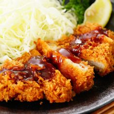 fried chicken with sauce and coleslaw on a plate