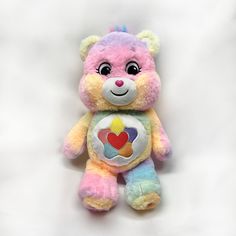 a colorful teddy bear with a heart on it's chest