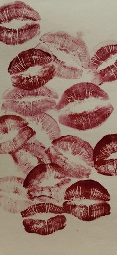 an image of lipstick kisses drawn on paper