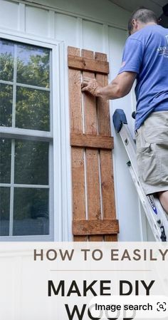 a man is painting the outside of a house with wood shutters and window trimming