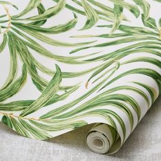 a green and white wallpaper with palm leaves on it's back droplet