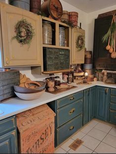 a kitchen filled with lots of different types of cooking utensils and wooden boxes