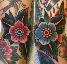 the legs are covered with tattoos and flowers