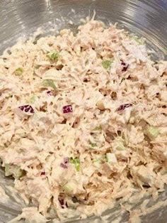 a bowl filled with chicken salad sitting on top of a table