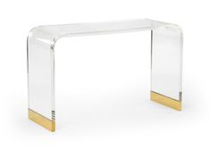 an acrylic console table with gold accents