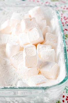 marshmallows in a glass dish on a table