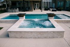 an outdoor hot tub next to a swimming pool