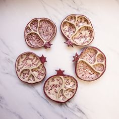 four pieces of fruit sitting on top of a white counter