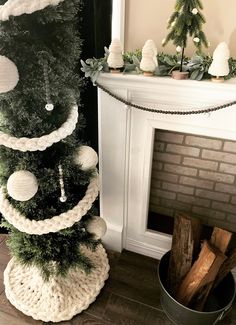 a crocheted christmas tree stands next to a fireplace