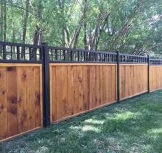 a wooden fence with black iron railings