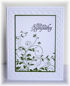 a sympathy card with green and white swirls on the front, in an ornate frame