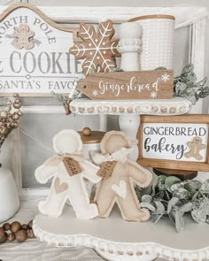 an assortment of gingerbread cookies displayed on a shelf in front of a wooden sign