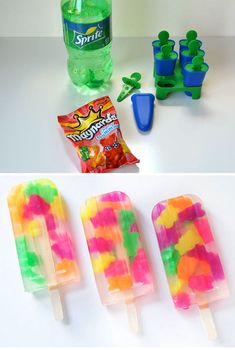 three different popsicles with gummy bears on them and one is filled with water