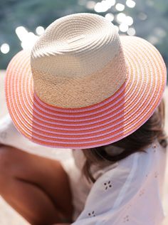 Ensure your face stays shaded this summer with Shiraleah's Armida Hat. Made from a natural paper straw base, this trendy beach hat features a chic orange and pink stripe design on the rim that can match any outfit. Pair with other items from Shiraleah to complete your look! Features a neutral straw color base with a pink and orange striped brim Shiraleah is a trend-driven lifestyle brand focused on the little gifts that make life special! Made from paper straw and raffia One size and adjustable Pink Straw Hat For Summer, Pink Straw Sun Hat For Summer, Pink Wide Brim Boater Hat For Vacation, Pink Flat Brim Boater Hat For Beach, Pink Fedora Straw Hat For Summer, Pink Short Brim Straw Hat For Beach Season, Pink Curved Brim Hat For Vacation, Pink Curved Brim Vacation Hat, Pink Vacation Hats With Curved Brim