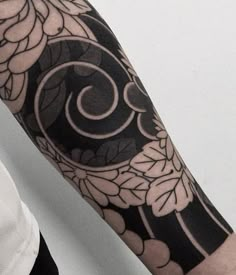 a person with a black and white tattoo on their arm