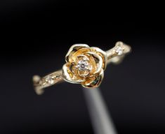 a close up view of a gold and diamond ring