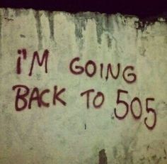 graffiti on the side of a building that says i'm going back to 505