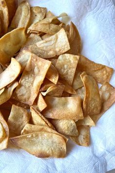 a pile of potato chips sitting on top of a white napkin