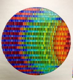 a multicolored circular artwork made out of strips of colored paper